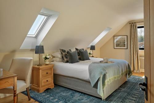 a bedroom with a bed and a chair at Meadow View House at Pudleston Court in Docklow