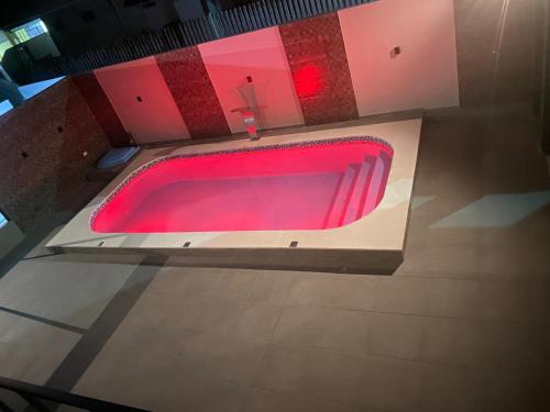 a red bath tub in a room with a red floor at HOTEL MORADA DO SOL in Pontal do Paraná