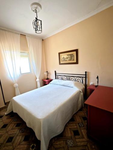 a bedroom with a bed and a window at El Andén del Hueznar in Constantina