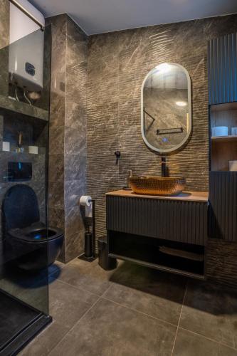 a bathroom with a toilet and a mirror at Villa Borik in Vrsi