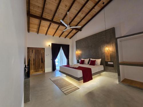 a bedroom with a bed and a ceiling fan at Villa Nutmeg Grove Galle in Galle