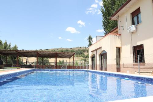 a large swimming pool next to a building at Hostal-Casa Rural Rosa-Nonna in Sigüenza