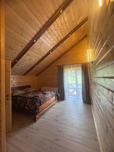 a large room with a bed and a window at Сузірʼя in Vorokhta