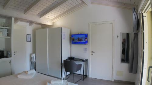 a room with a desk and a cabinet and a chair at OnSuite With Wiew Near COMO in Erba