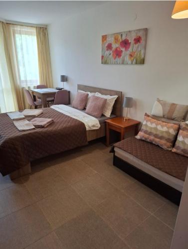 a hotel room with two beds and a couch at Cozy studio 125 in Villa Park in Borovets