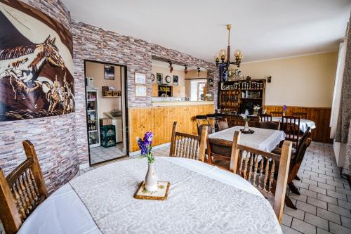 a dining room with a table and chairs at Stáj Newport in Dolní Domaslavice