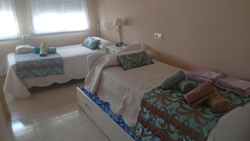 a bedroom with two twin beds and a window at Casa 3 min andando playa AC WiFi 8 pax Doñana in Matalascañas