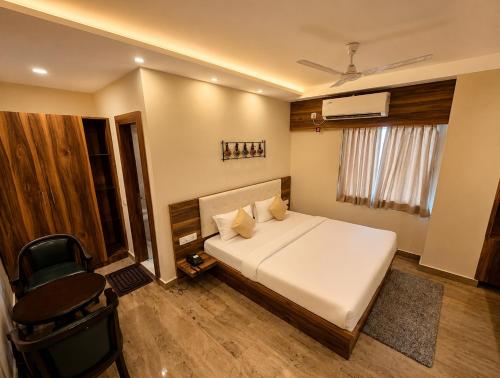 a bedroom with a bed and a desk and a chair at Namastey Puri Hotel - Near Jagannath Dham Temple With Restaurant And Parking Facility Fully Air Conditioning Room in Puri