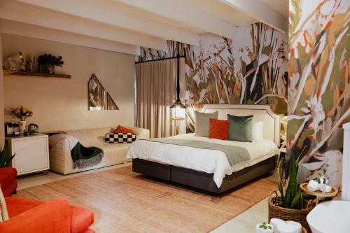 a bedroom with a bed and a living room at Bly B&B in Pretoria