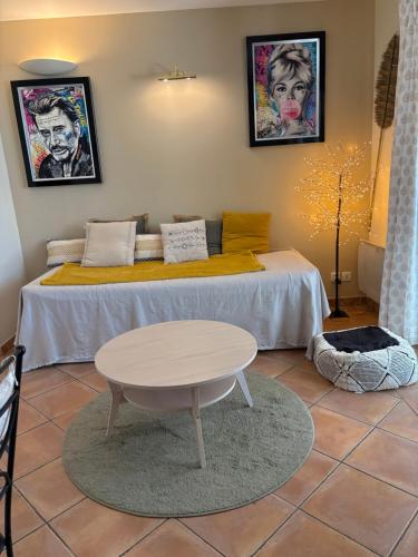 a room with a bed with a table in it at La Calade in L'Isle-sur-la-Sorgue