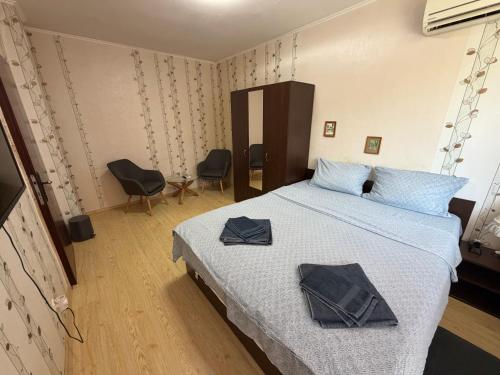a bedroom with a bed with two towels on it at Izgrev Sarafovo in Burgas
