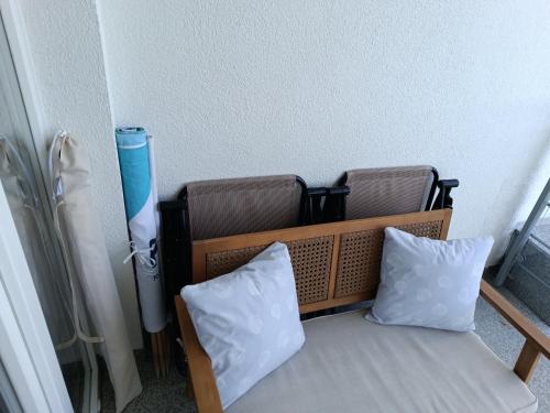 a room with a bed with two pillows and a radiator at Apartament 512 in Dziwnówek