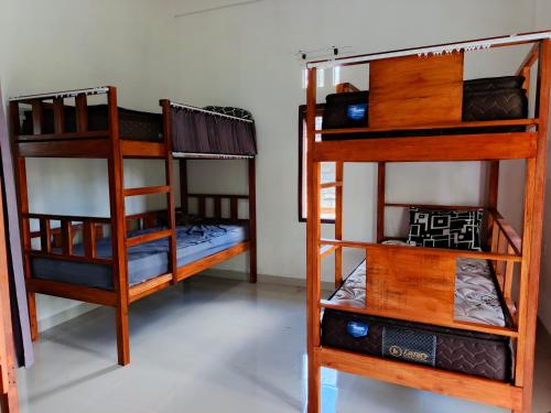 a group of bunk beds in a room at Tetebatu Backpackers Base in Selong
