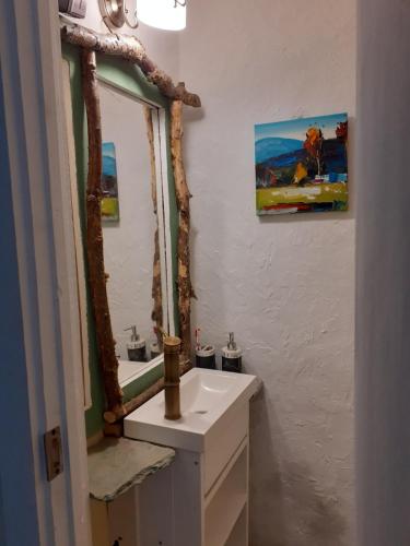 a bathroom with a sink and a mirror at Stone House Rooms near Kavala in Amisianá
