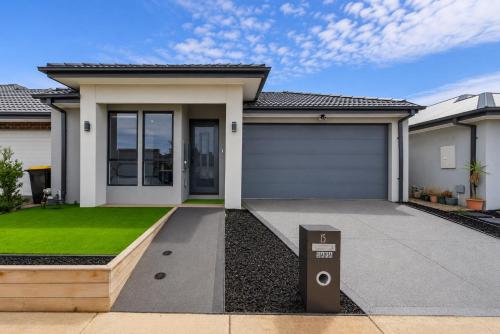 a house with a garage in front of it at Sara by Ready Set Stay in Caroline Springs