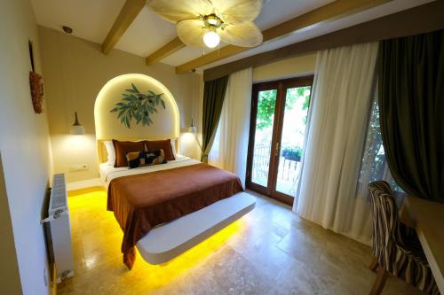 a bedroom with a large bed with a large window at Palace Hotel Olive Odore in Küçükkuyu