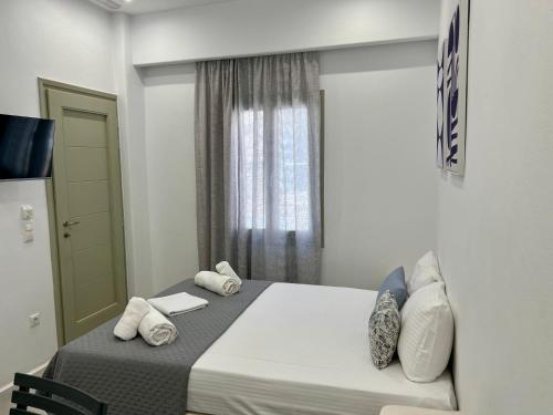 a bedroom with a bed with towels on it at Ione Inn in Naxos Chora