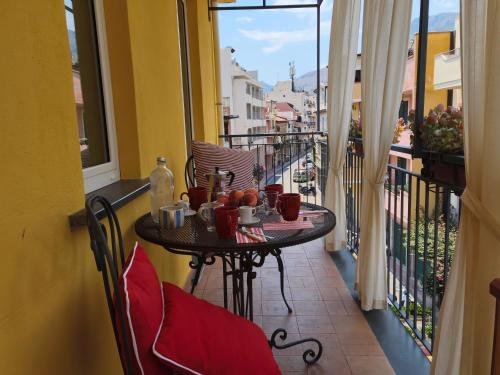 a table on a balcony with food and drinks on it at Case Borgo Vacanze in Letojanni