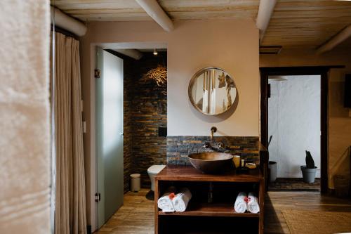 a bathroom with a sink and a mirror on the wall at Bly B&B in Pretoria