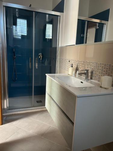 a bathroom with a glass shower and a sink at B&B Casa Torre -Amalficoast room in Agerola