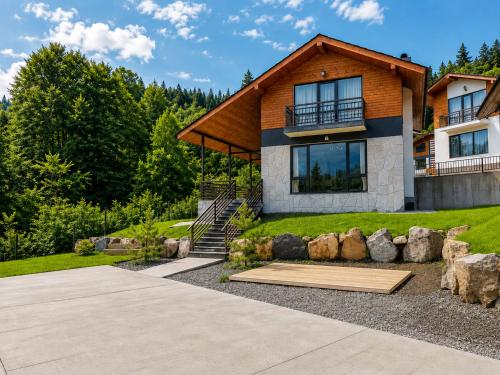 a home with a large house with a roof at Crown Villa Bakuriani in Bakuriani