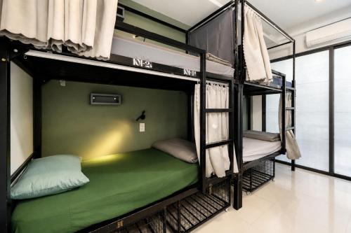 a couple of bunk beds in a room at Two Horses Hostel in Hoi An