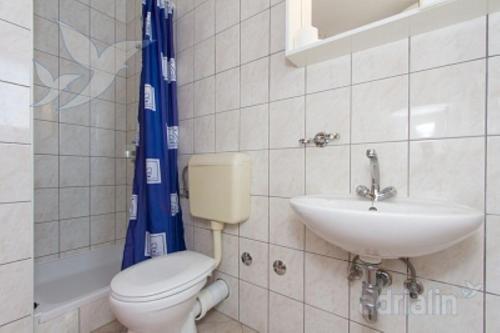 a bathroom with a toilet and a sink at Villa Nada - STUDIO 11 in Duće