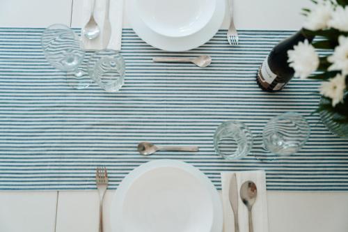 a table with a plate and utensils on a table at Domki Wierzbówka- Basen, Sauna, Rowery in Mielno