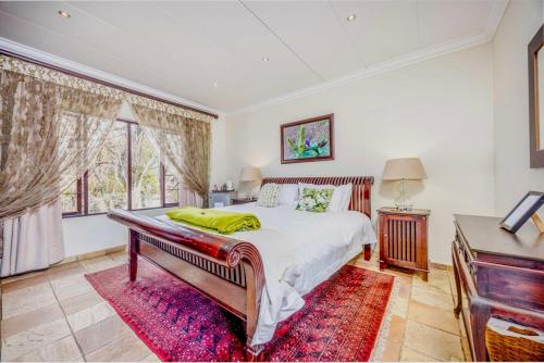 a bedroom with a bed and a large window at 42onKing in Centurion