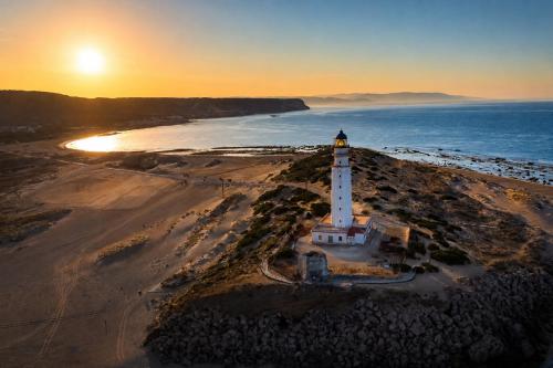 an aerial view of a lighthouse on the beach at Kampaoh Hostel Trafalgar in Los Caños de Meca