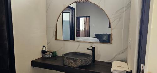 a bathroom with a sink and a mirror at Prospectors Inn in Lüderitz