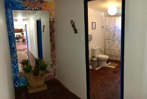 a bathroom with a mirror and a toilet at Posada Atacameña in San Pedro de Atacama
