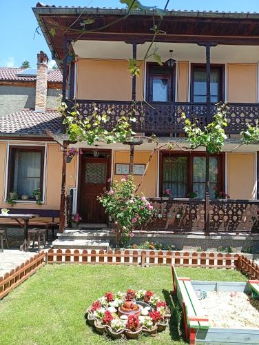 a house with a garden in front of it at Guest Rooms Dona in Koprivshtitsa
