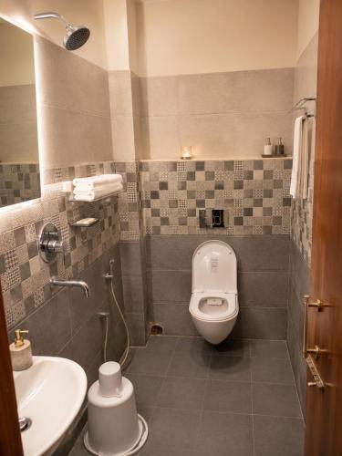 a bathroom with a toilet and a sink at Hotel Baikuntha International Puri Near Sea Beach With Parking AC Or Non AC Both Room in Puri