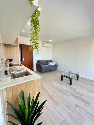 a kitchen and a living room with a couch at Cala Crancs - Sea Views in Salou