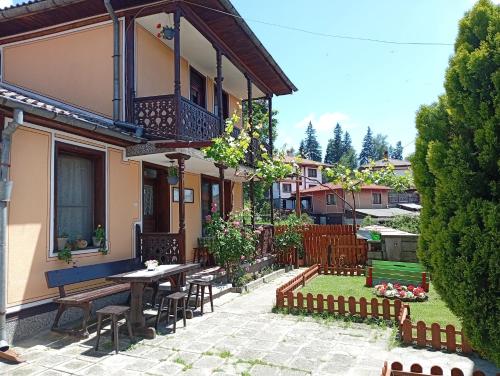 a patio of a house with a table and chairs at Guest Rooms Dona in Koprivshtitsa