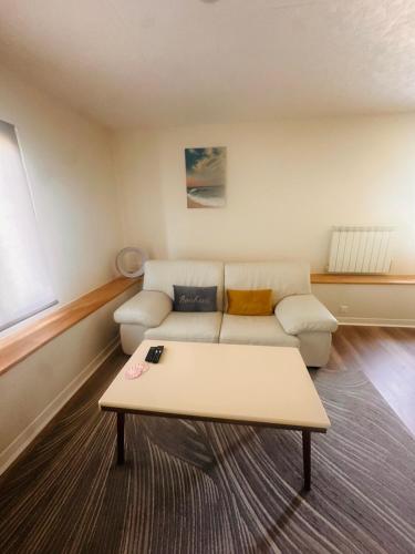 a living room with a couch and a coffee table at Pure comfort in Entrelacs