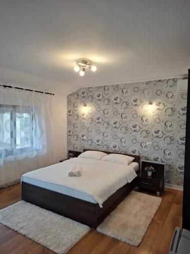 a bedroom with a large bed with a large wall at Pensiunea Turist in Techirghiol