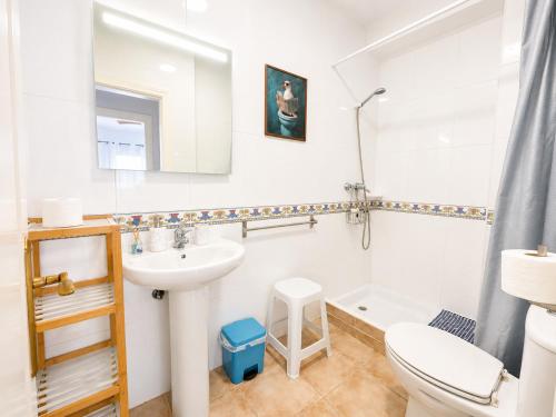 a white bathroom with a sink and a toilet at Mirador de las Gaviotas in Mojácar