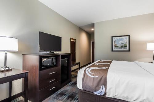 a hotel room with a bed and a flat screen tv at Quality Inn Pleasant View in Pleasant View