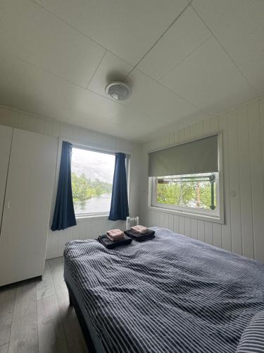 a bedroom with a bed and a window at House on the lake in Bogen