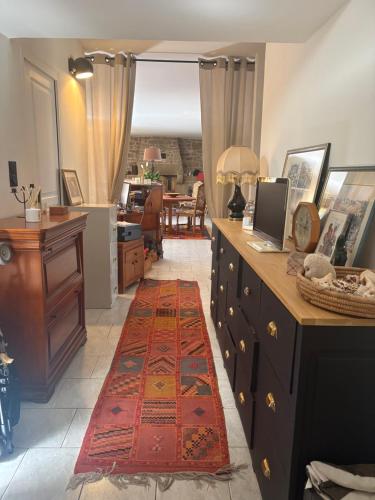 a kitchen with a red rug on the floor at Les Terrasses de Rostevel in Brech