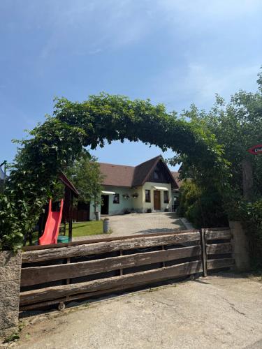 an arch over a fence in front of a house at Chatka Hanka in Terchová
