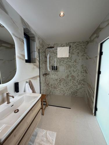 a bathroom with a sink and a mirror at View Villas Collection in Vinišće