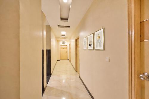 a hallway with a long hall with white walls at FabHotel Prime Nakshatra Inn in Hyderabad