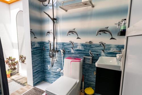 a bathroom with a shower with dolphins in the water at Villa Argento in Rimbudu