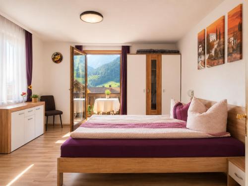 a bedroom with a large bed with a large window at Bad Hindelang in Bad Hindelang