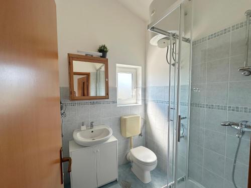 a bathroom with a sink and a toilet and a shower at Apartments Mester in Sveti Anton