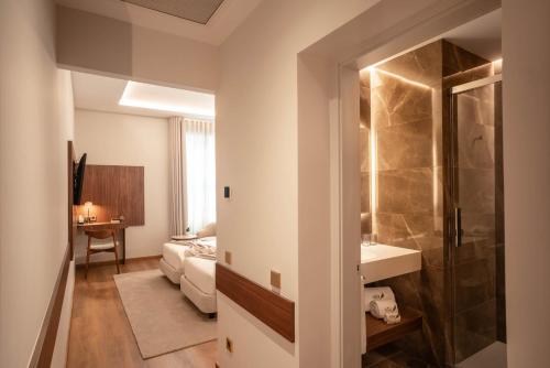 a bathroom with a sink and a shower in a room at The Book Hotel in Horta