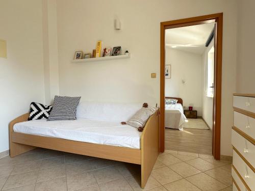 a bedroom with a bed and a mirror at Apartments Mester in Sveti Anton